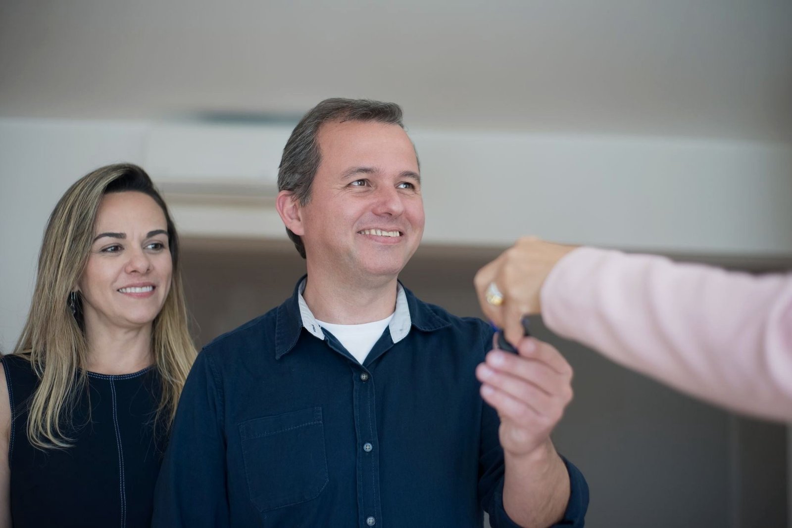 Couple collecting the keys to their new car